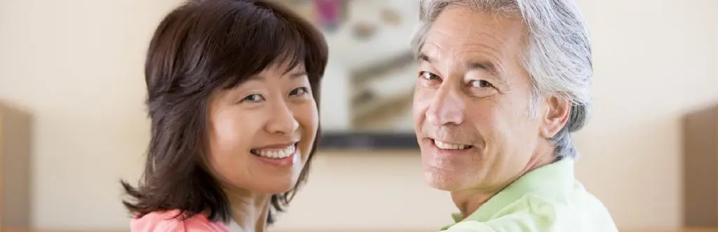 Couple watching television smiling