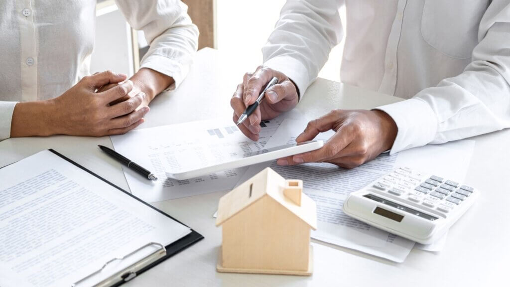 calculator and documents representing investment property planning